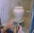 Spraying glaze on pottery